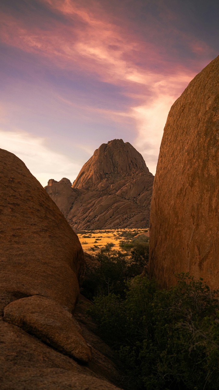 Spitzkoppe peak framed between massive granite boulders at sunset
