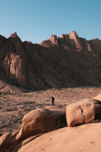 Traveller photographing the rugged granite landscape at Spitzkoppe