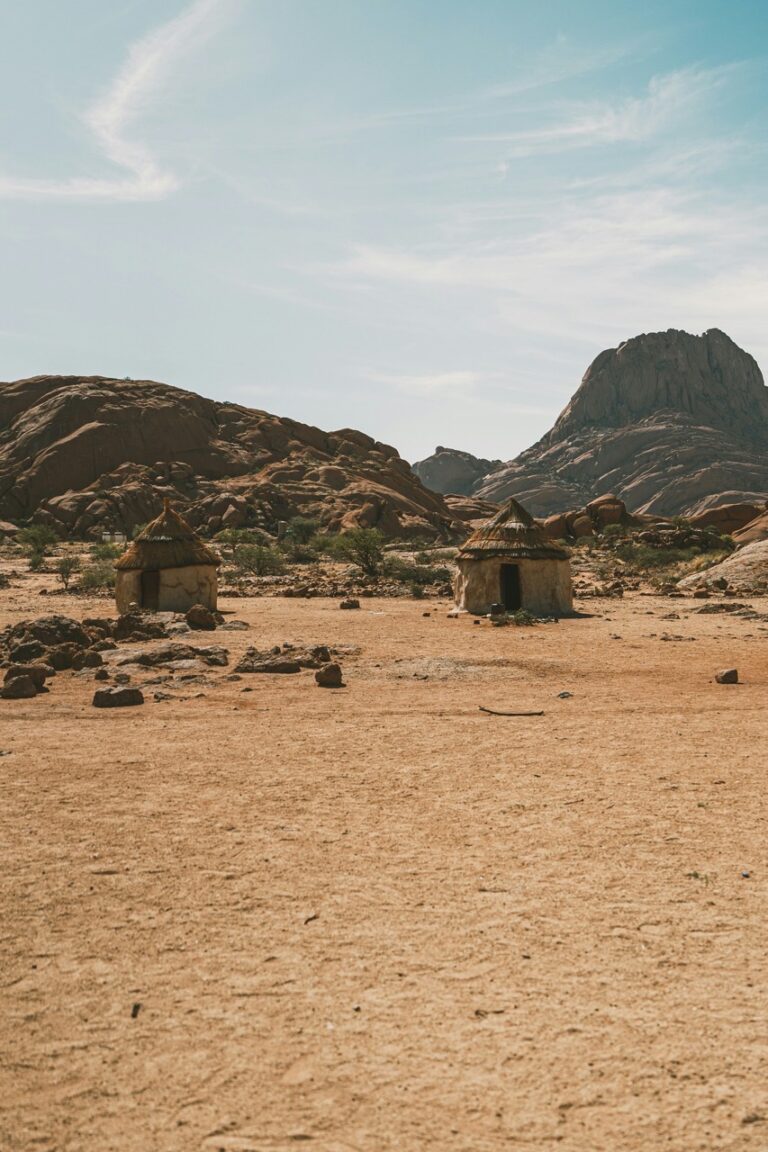 Traditional shelters beneath the granite peaks at Spitzkoppe