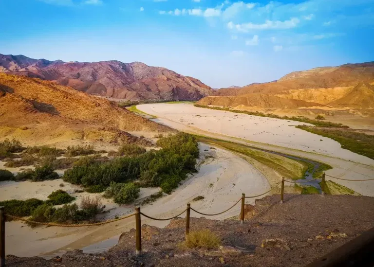 Broad sandy river valley among colourful desert hills on the Skeleton Coast Safari