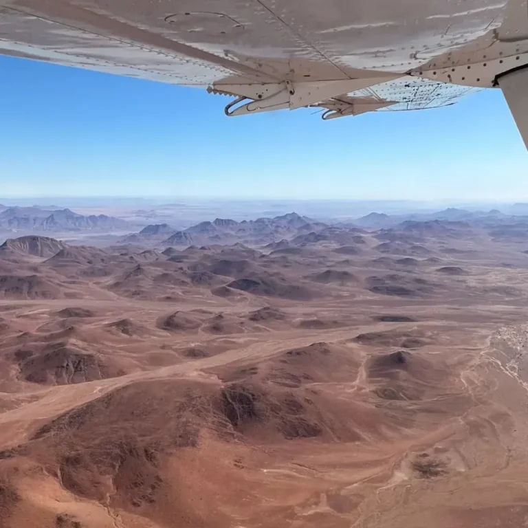Desert ridges seen beneath a light-aircraft wing on the Skeleton Coast Safari