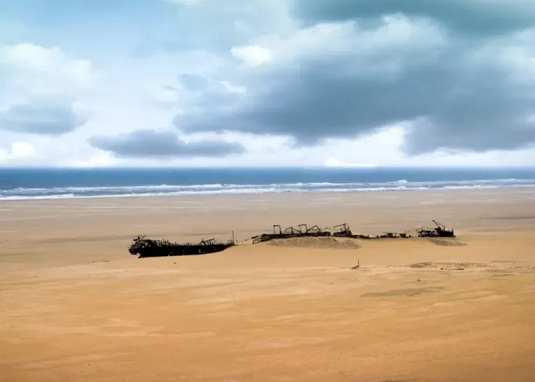 Shipwreck remains on a sandy Skeleton Coast beach