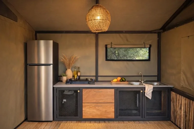 Self-catering kitchenette with fridge-freezer, gas hob and sink at Buffalo Tented Camp