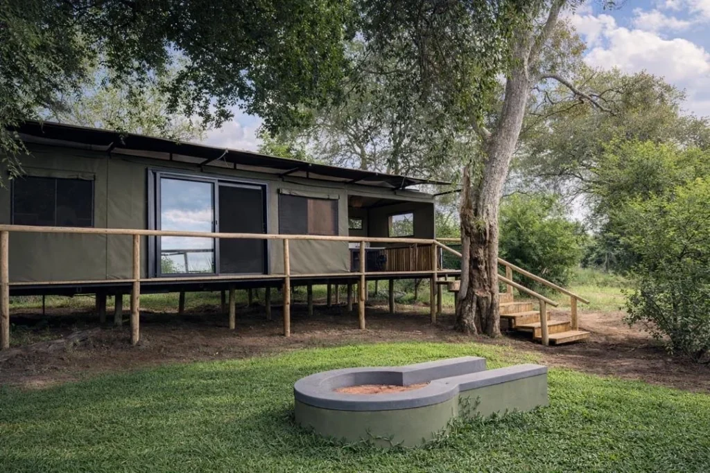 Buffalo Tented Camp tent exterior with timber deck, lawn and private fire pit