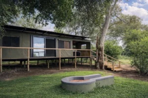 Buffalo Tented Camp tent exterior with timber deck, lawn and private fire pit
