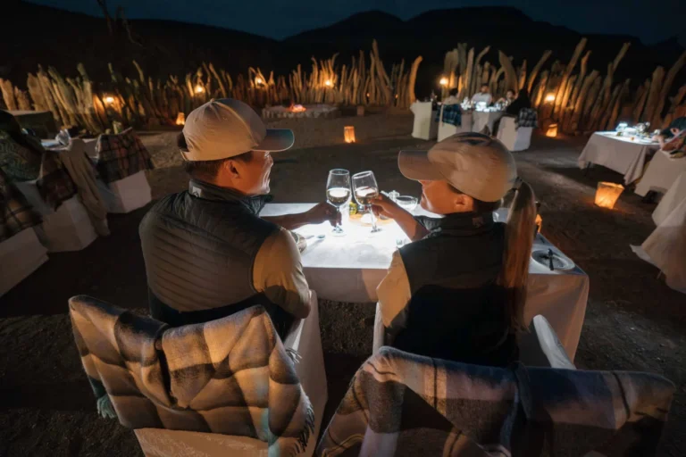 Guests dining by candlelight in the Damaraland Camp boma
