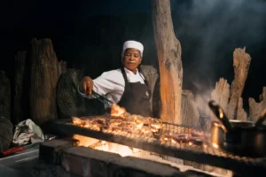 Chef cooking over an open fire at Damaraland Camp