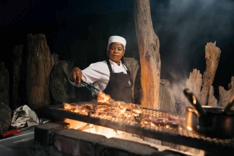 Chef cooking over an open fire at Damaraland Camp