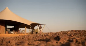 Canvas roofs and rocky landscape at Desert Rhino Camp