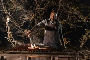 Chef cooking over an open fire at Desert Rhino Camp