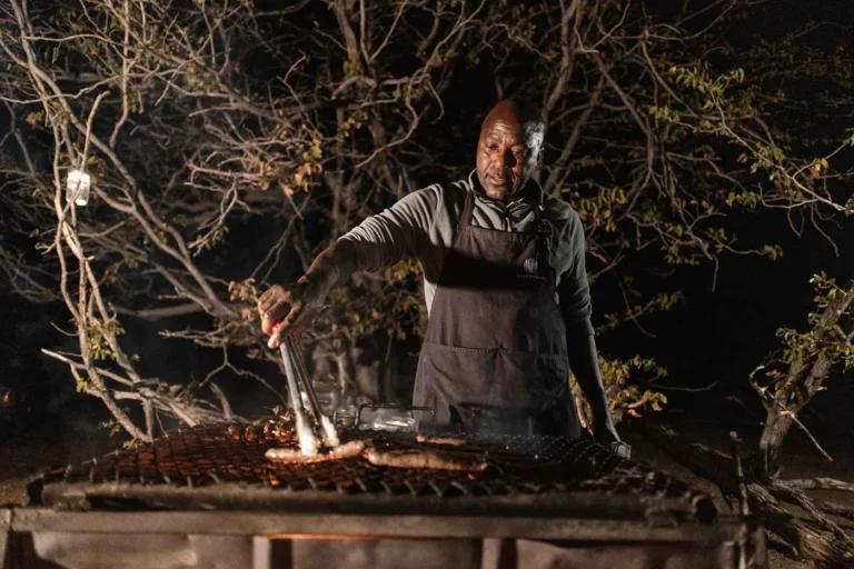 Chef cooking over an open fire at Desert Rhino Camp