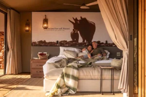 Guests resting in a canvas-and-stone Desert Rhino Camp suite