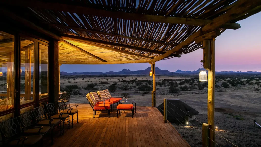 Wilderness Doro Nawas Camp deck overlooking Damaraland at dusk