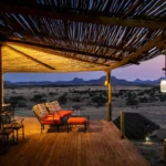 Wilderness Doro Nawas Camp deck overlooking Damaraland at dusk