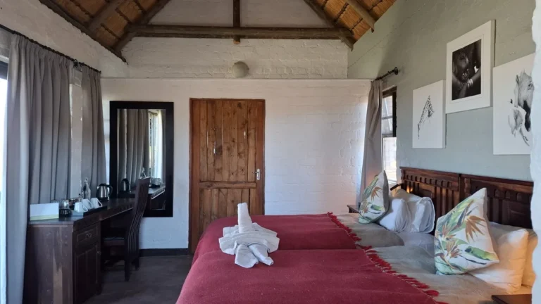 Chalet bedroom with wooden furnishings at Grootberg Lodge