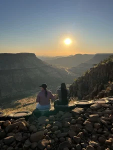 Guests watching the low sun over the valley near Grootberg Lodge