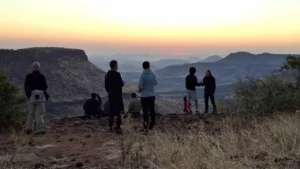 Guests enjoying a sunset viewpoint above the valley at Grootberg