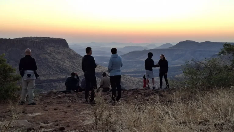 Guests enjoying a sunset viewpoint above the valley at Grootberg