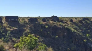 Rocky escarpment and green slopes near Grootberg Lodge
