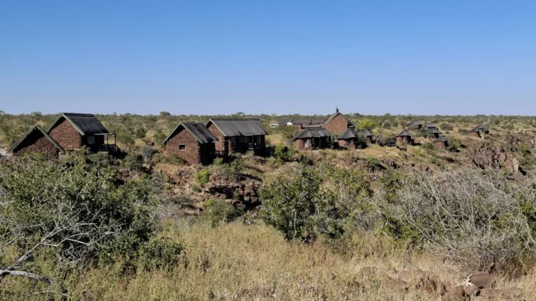 Stone-and-thatch chalets across the Grootberg plateau