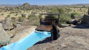 Hoada splash pool set among granite boulders with landscape views