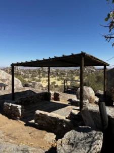 Covered seating area among granite boulders at Hoada