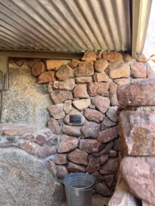 Stone-walled shower area at Hoada Campsite
