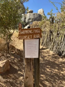 Hoada camp sign beside a wooden fence