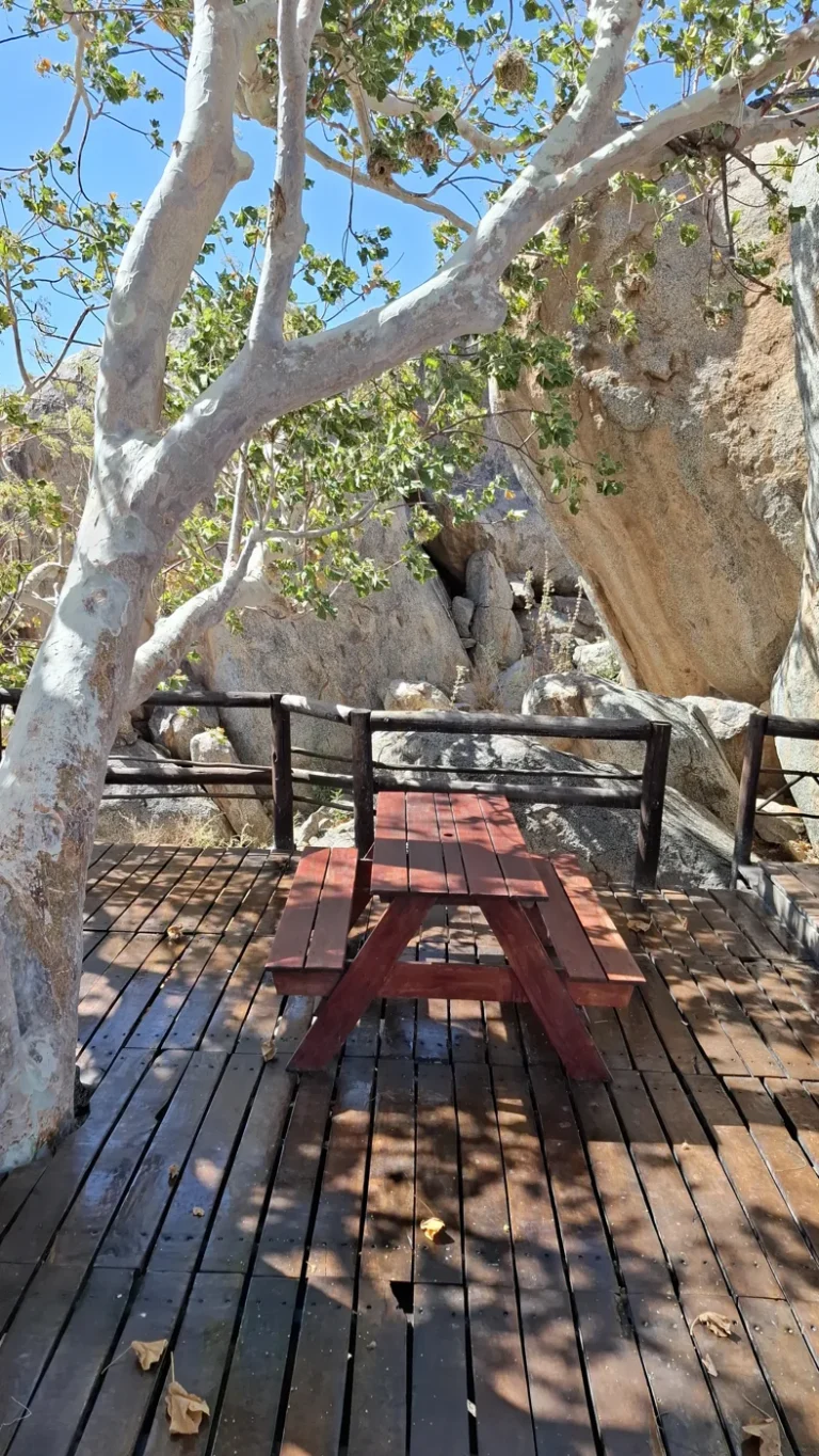 Shaded seating deck among rocks at Hoada Campsite