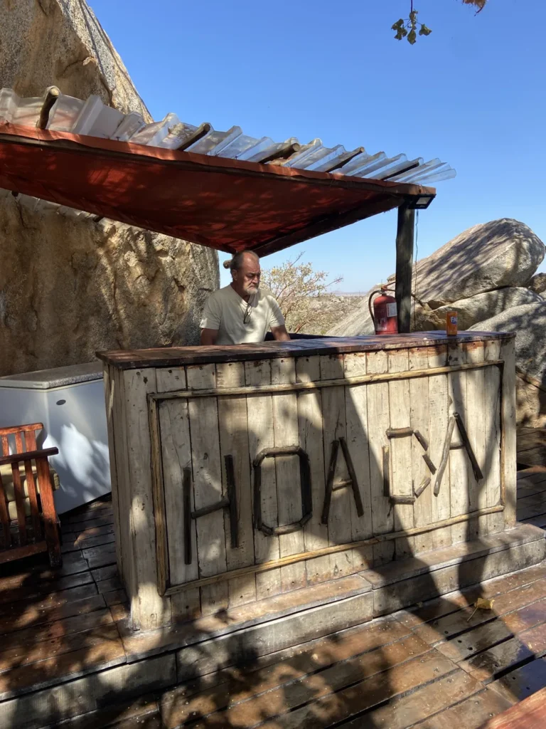 Hoada sign beside a rustic camp structure