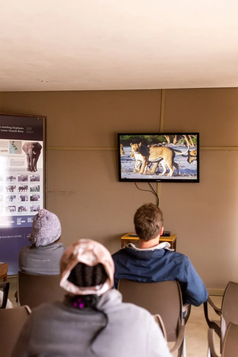 Guests watching a wildlife research presentation at Hoanib Skeleton Coast Camp