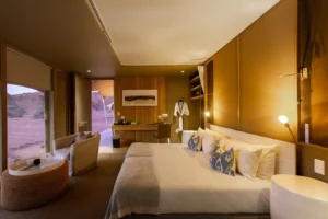 Bed and seating inside a Hoanib Skeleton Coast Camp suite