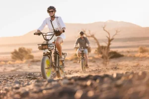 Guests riding electric fatbikes in the Kulala desert landscape