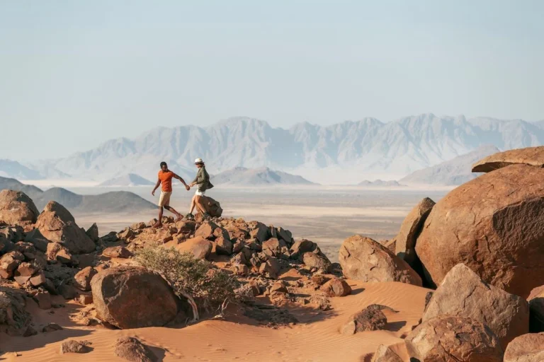 Guests walking among rocky outcrops in the Little Kulala reserve