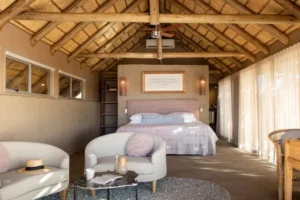 Thatched Little Kulala guest suite with bed and sitting area