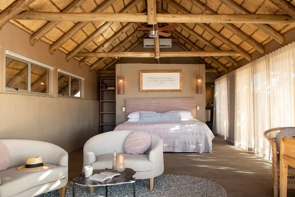 Thatched Little Kulala guest suite with bed and sitting area