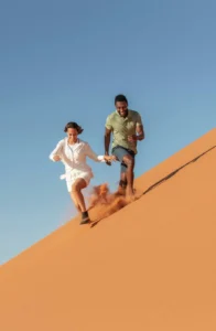Guests walking down a red Sossusvlei dune