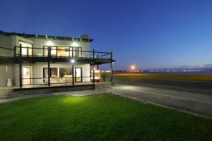 Oyster Box Guesthouse exterior illuminated after sunset